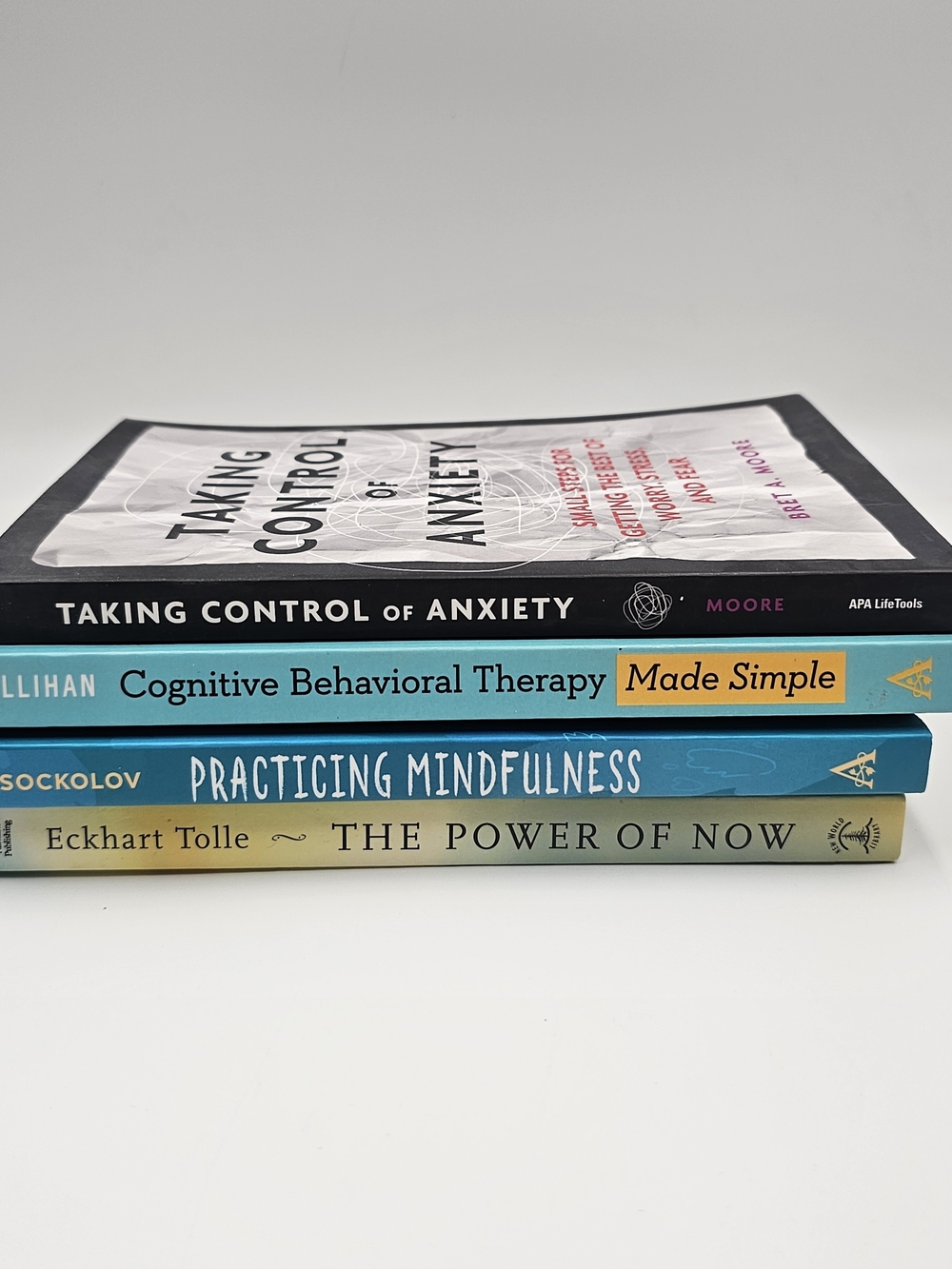Stack of Mindfulness & CBT Books in Black, Teal, Blue, and Cream